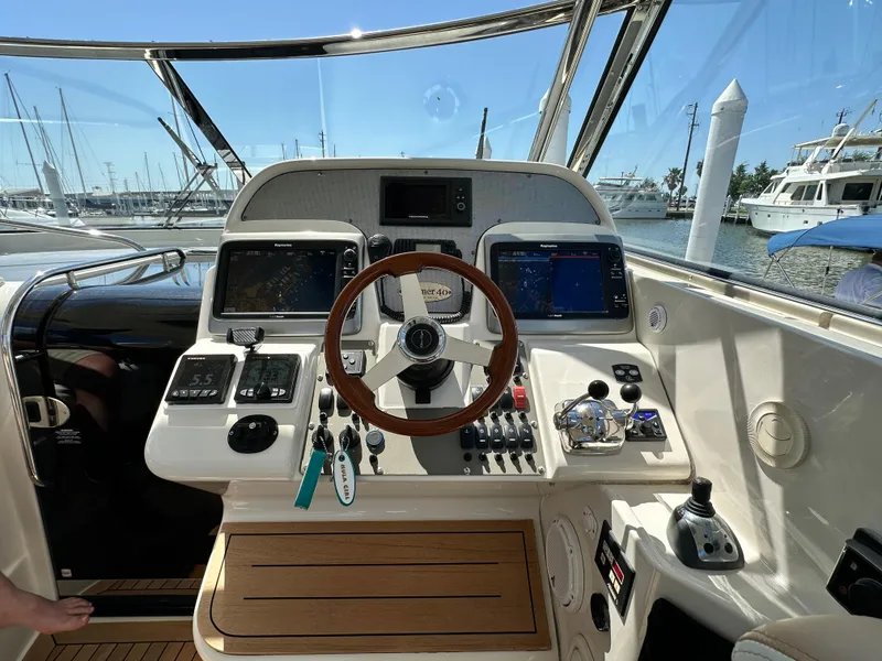 Slide: The Image of Helm of 2007 Chris-Craft Roamer 40 yacht with steering wheel and navigation controls. - 19
