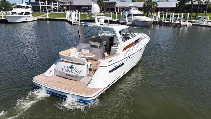 Slide: The Image of 2007 Chris-Craft Roamer 40 yacht cruising in a marina, showcasing elegant design and luxury. - 2