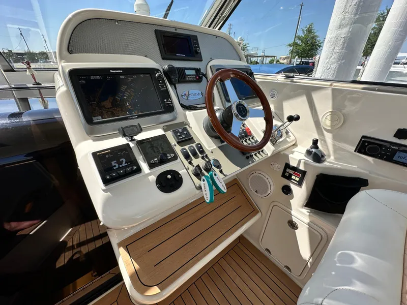 Slide: The Image of 2007 Chris-Craft Roamer 40 helm with modern navigation equipment and wooden steering wheel. - 20