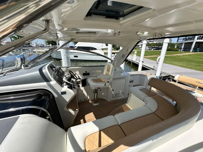 Slide: The Image of 2007 Chris-Craft Roamer 40 yacht interior with helm and seating area at dock. - 32
