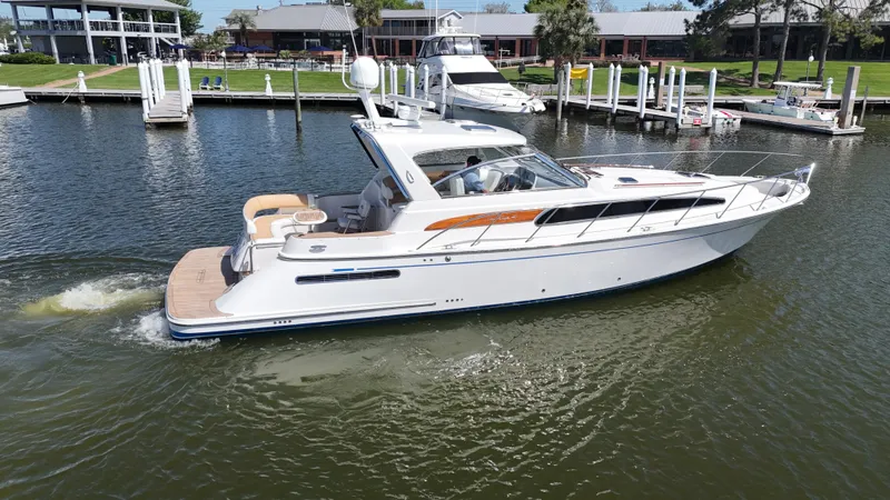 Slide: The Image of 2007 Chris-Craft Roamer 40 yacht cruising in a marina, showcasing sleek design and luxury. - 4
