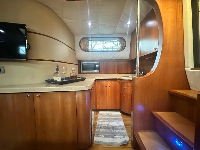 Slide: The Image of Luxurious 2007 Chris-Craft Roamer 40 yacht interior with wood cabinetry and modern amenities. - 41