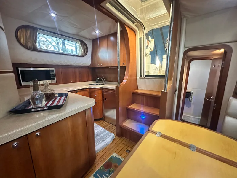 Slide: The Image of Luxurious 2007 Chris-Craft Roamer 40 yacht interior with wood cabinetry and modern amenities. - 42