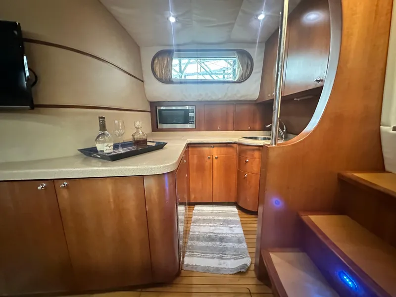 Slide: The Image of Luxurious 2007 Chris-Craft Roamer 40 yacht interior with modern kitchen and wooden cabinetry. - 44