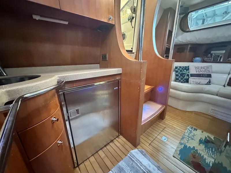 Slide: The Image of 2007 Chris-Craft Roamer 40 interior with wood finish, kitchenette, and seating area. - 46