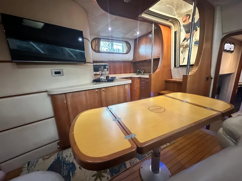 Slide: The Image of 2007 Chris-Craft Roamer 40 interior with wood cabinetry, dining table, and modern amenities. - 49