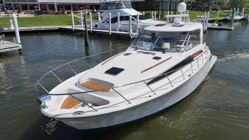 Slide: The Image of 2007 Chris-Craft Roamer 40 yacht docked in a marina, showcasing sleek design and luxury features. - 6