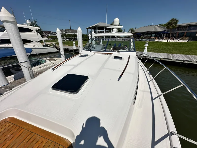 Slide: The Image of 2007 Chris-Craft Roamer 40 yacht docked, showcasing sleek deck design and marina setting. - 8