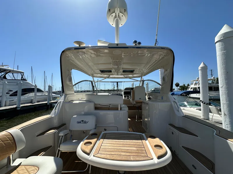 Slide: The Image of 2007 Chris-Craft Roamer 40 yacht interior with seating and table, docked at marina. - 9