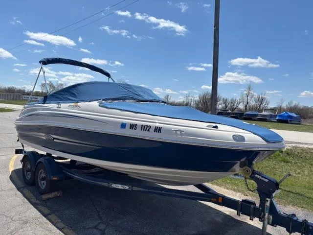 Slide: The Image of 2007 Sea Ray 200 Sundeck boat on trailer under blue sky. - 1