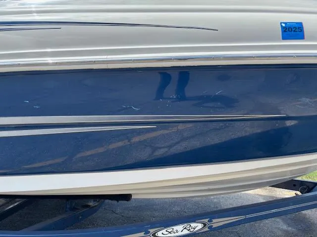 Slide: The Image of 2007 Sea Ray 200 Sundeck boat with blue and white hull on trailer. - 13