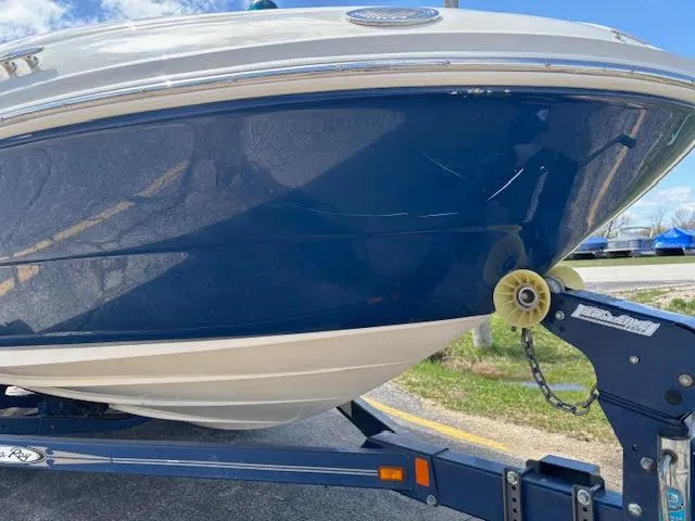 Slide: The Image of 2007 Sea Ray 200 Sundeck boat on trailer, blue and white hull, sunny day. - 14