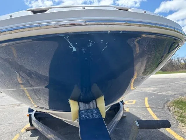 Slide: The Image of 2007 Sea Ray 200 Sundeck boat on trailer, blue hull, parked outdoors. - 15