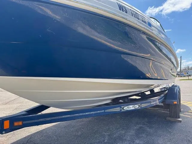 Slide: The Image of 2007 Sea Ray 200 Sundeck boat on trailer, blue hull, sunny day. - 16