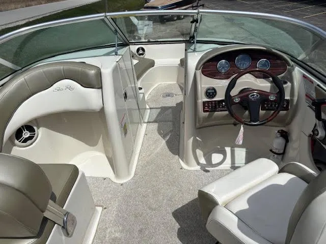 Slide: The Image of Interior of a 2007 Sea Ray 200 Sundeck boat, featuring steering wheel and seating. - 23