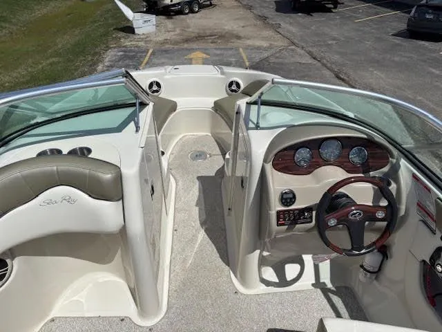 Slide: The Image of 2007 Sea Ray 200 Sundeck interior with steering wheel, dashboard, and seating area. - 24