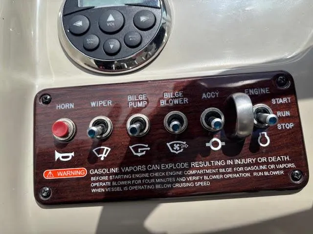 Slide: The Image of Control panel of a 2007 Sea Ray 200 Sundeck boat with various switches and warning label. - 29