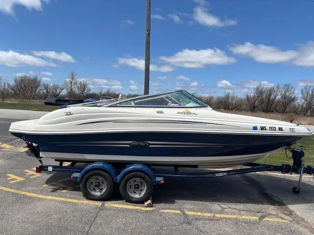 Slide: The Image of 2007 Sea Ray 200 Sundeck boat on trailer under a clear blue sky. - 3