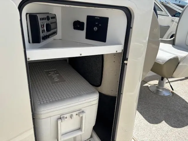 Slide: The Image of 2007 Sea Ray 200 Sundeck storage compartment with cooler and control panel. - 33