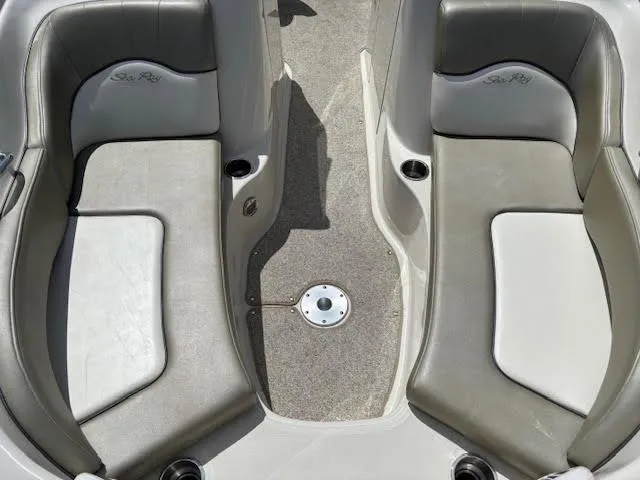 Slide: The Image of 2007 Sea Ray 200 Sundeck interior seating with gray upholstery and cup holders. - 35