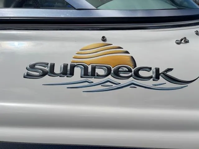 Slide: The Image of 2007 Sea Ray 200 Sundeck logo with sun and wave design on boat exterior. - 4