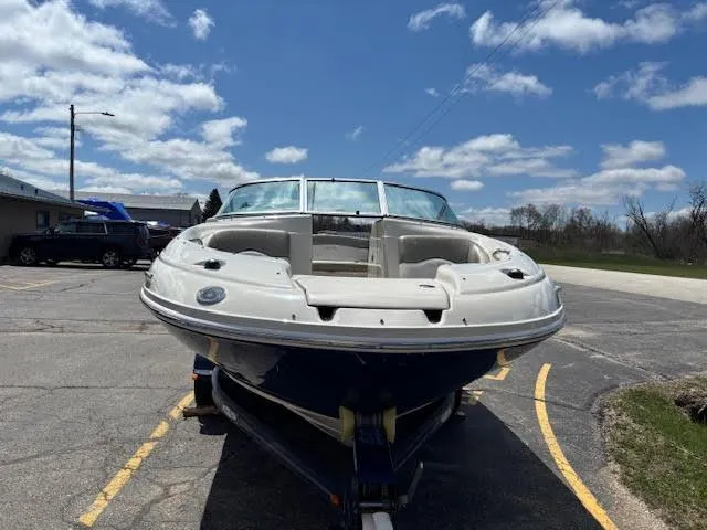 Slide: The Image of 2007 Sea Ray 200 Sundeck boat on trailer under a partly cloudy sky. - 5