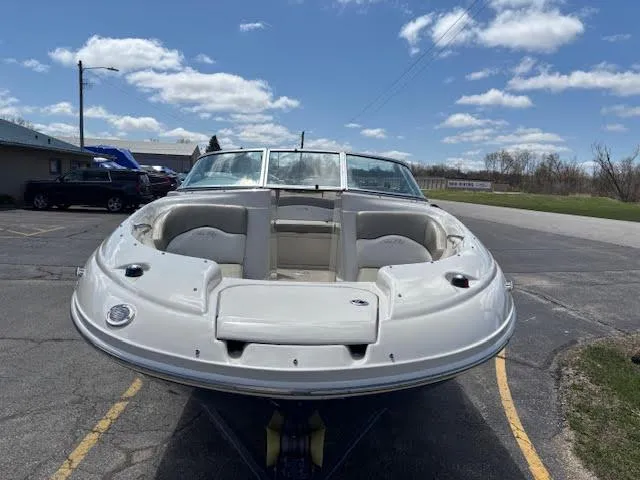 Slide: The Image of 2007 Sea Ray 200 Sundeck boat on trailer under a clear blue sky. - 6