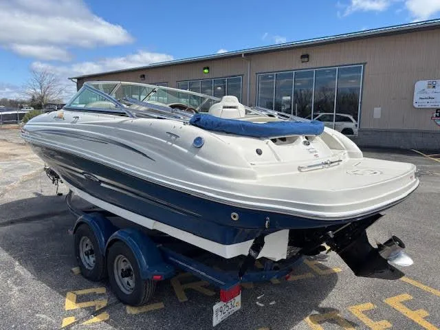 Slide: The Image of 2007 Sea Ray 200 Sundeck boat on trailer, parked outdoors near a building. - 9