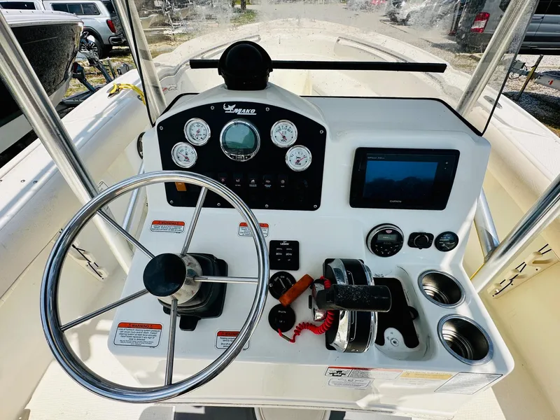 Slide: The Image of Control panel of a 2014 Mako 204 CC boat with steering wheel and gauges. - 10