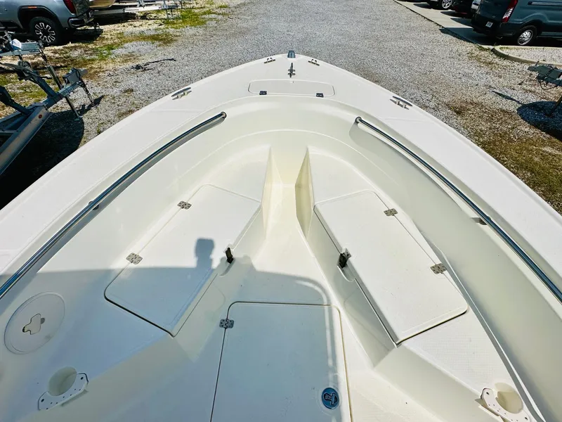 Slide: The Image of 2014 Mako 204 CC boat deck with storage compartments and seating. - 13