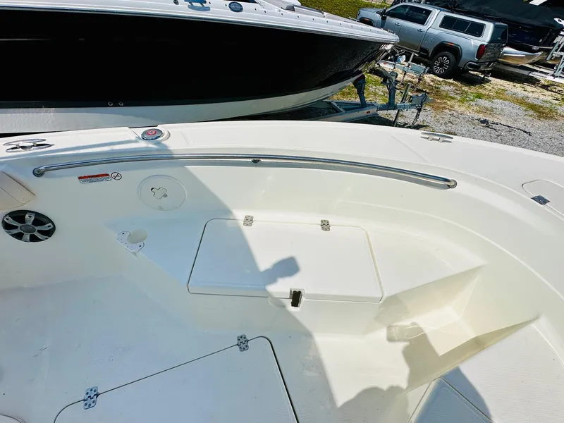 Slide: The Image of 2014 Mako 204 CC boat interior with storage compartments and railing. - 15