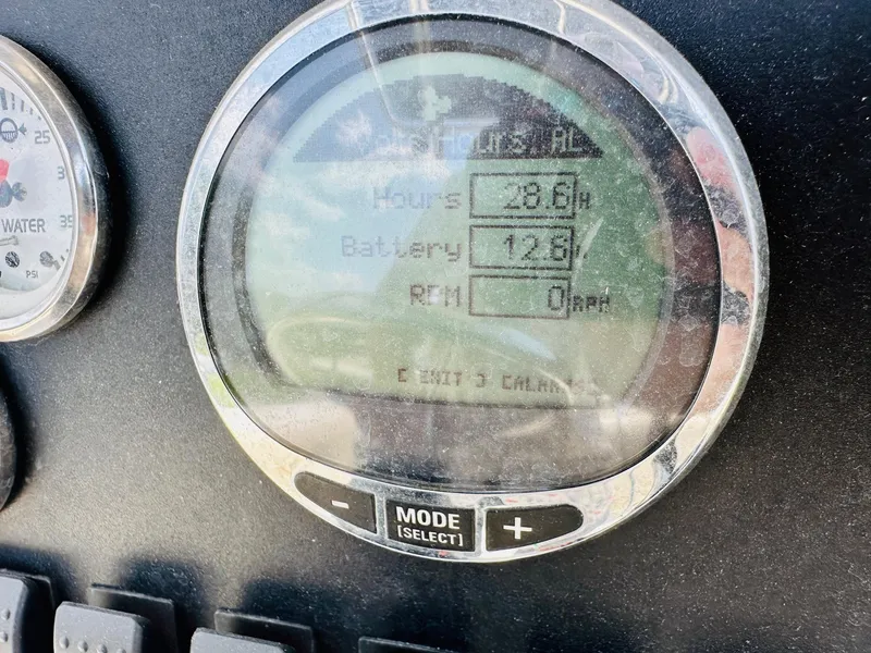 Slide: The Image of Close-up of a 2014 Mako 204 CC boat dashboard display showing hours, battery, and RPM. - 22