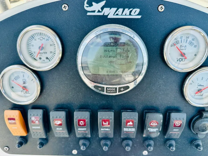 Slide: The Image of Dashboard of a 2014 Mako 204 CC boat with gauges and switches. - 23