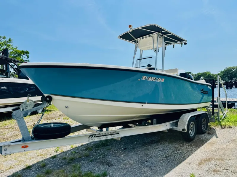 Slide: The Image of 2014 Mako 204 CC boat on trailer, blue hull, parked outdoors. - 5