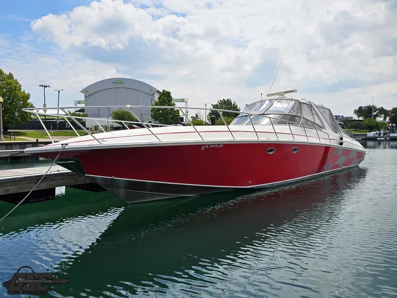 The Image of 2006 Fountain 48 Express Cruiser in vibrant red docked at a marina. - 1