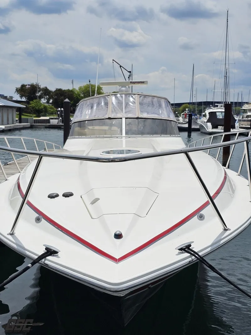 Slide: The Image of 2006 Fountain 48 Express Cruiser docked at marina under cloudy sky. - 13