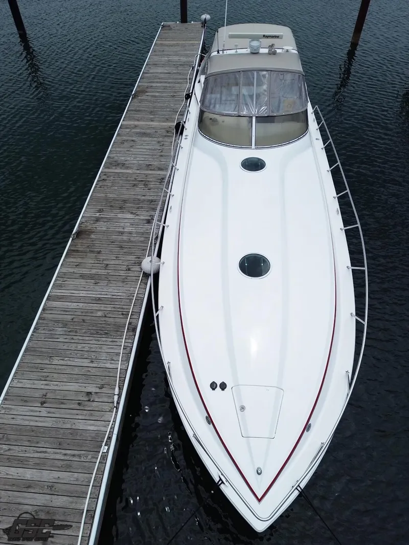 Slide: The Image of 2006 Fountain 48 Express Cruiser docked, aerial view showcasing sleek design and spacious deck. - 15