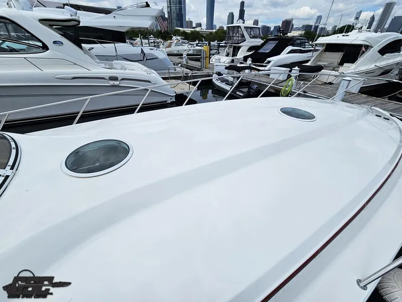 Slide: The Image of 2006 Fountain 48 Express Cruiser docked at marina with city skyline. - 18