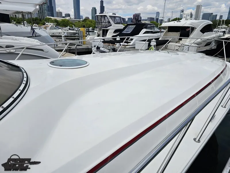 Slide: The Image of 2006 Fountain 48 Express Cruiser docked in marina with city skyline in background. - 19