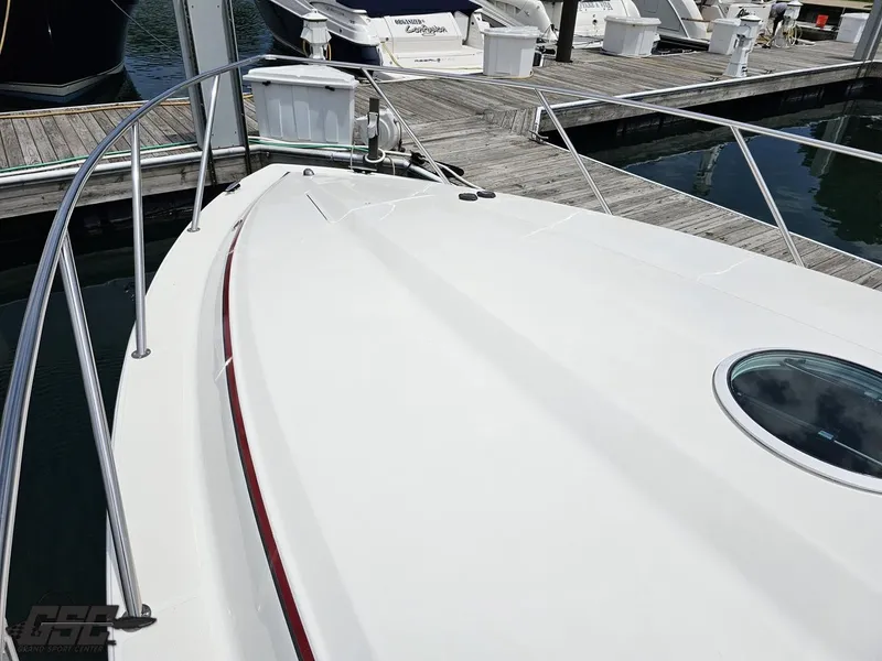 Slide: The Image of 2006 Fountain 48 Express Cruiser docked, showcasing sleek white deck and railings. - 21