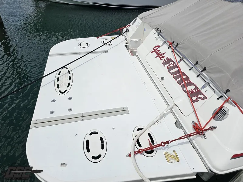 Slide: The Image of 2006 Fountain 48 Express Cruiser stern with cover and ropes, docked in marina. - 24