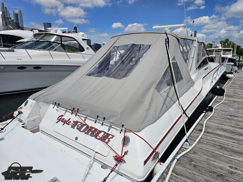 Slide: The Image of 2006 Fountain 48 Express Cruiser docked, featuring a covered deck and sleek design. - 25