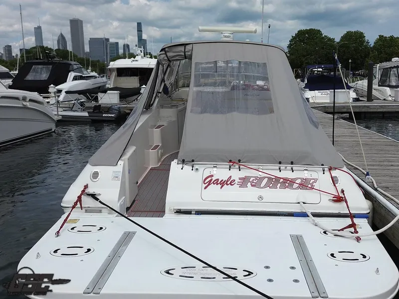 Slide: The Image of 2006 Fountain 48 Express Cruiser docked in marina with city skyline in background. - 26