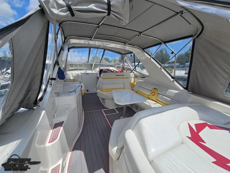 Slide: The Image of 2006 Fountain 48 Express Cruiser interior with white seating and canopy. - 28