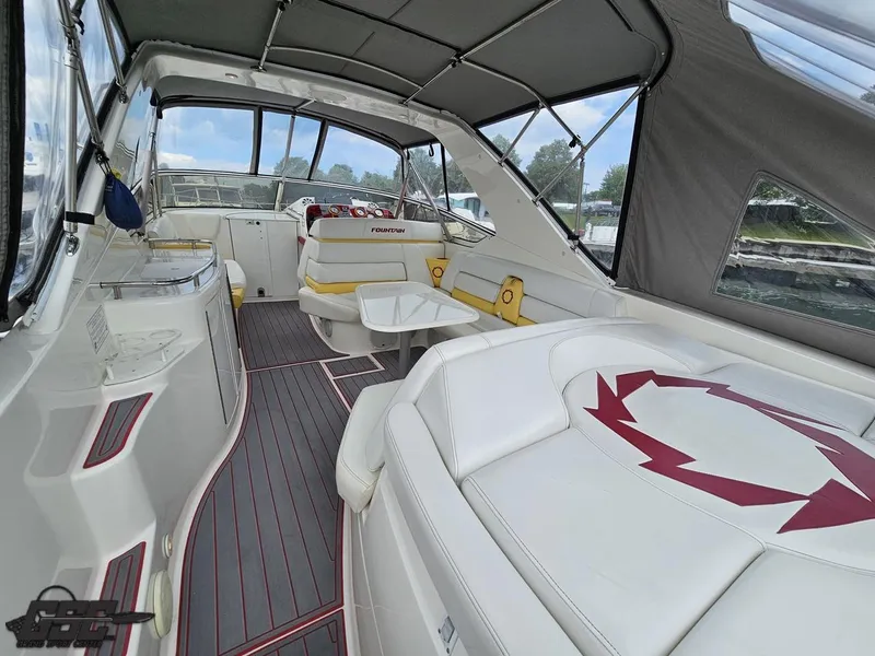 Slide: The Image of 2006 Fountain 48 Express Cruiser interior with white seating and canopy. - 31