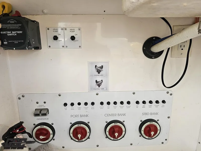 Slide: The Image of Control panel of a 2006 Fountain 48 Express Cruiser with battery switches and bank controls. - 36