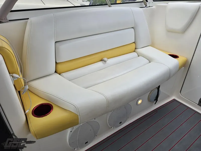 Slide: The Image of 2006 Fountain 48 Express Cruiser interior with white and yellow seating, cup holders, and speakers. - 39