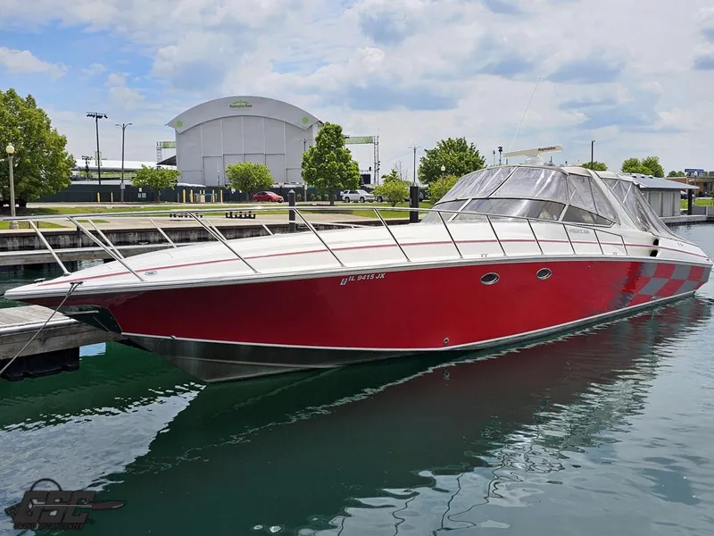 Slide: The Image of 2006 Fountain 48 Express Cruiser in vibrant red docked at a marina. - 4