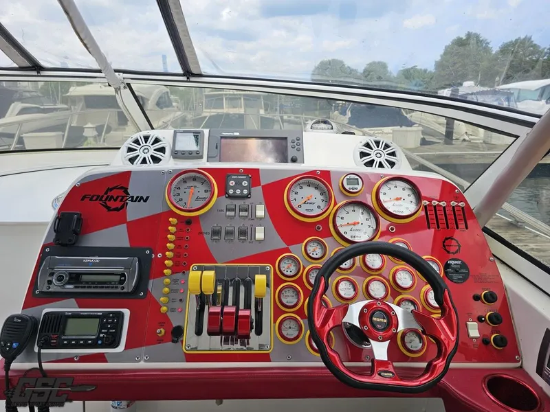 Slide: The Image of Control panel of a 2006 Fountain 48 Express Cruiser with red and yellow gauges. - 46