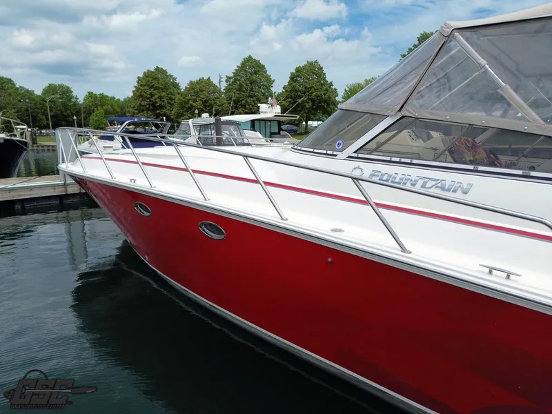 Slide: The Image of 2006 Fountain 48 Express Cruiser with red hull docked in marina. - 5